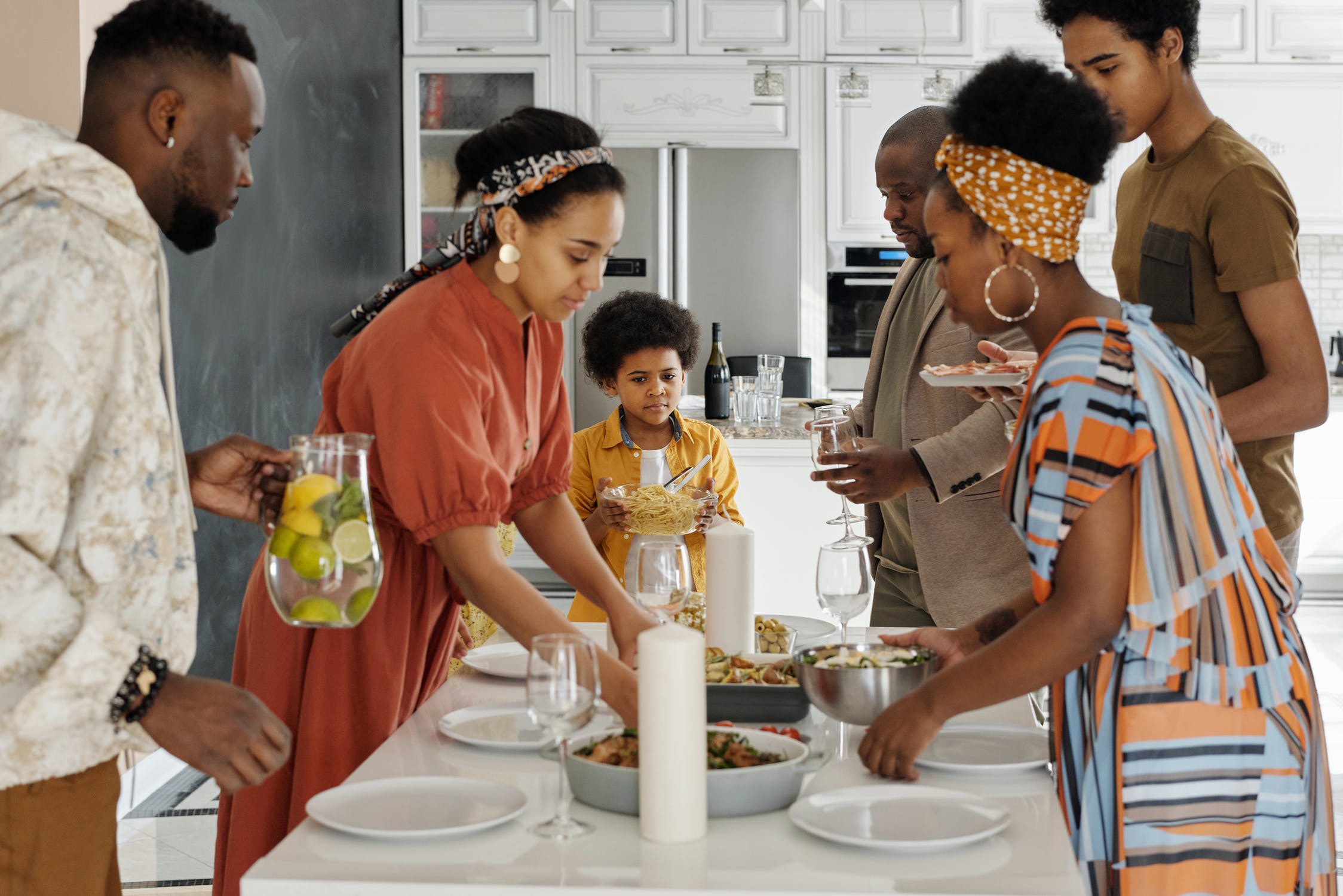 Family serving and eating food in the kitchen