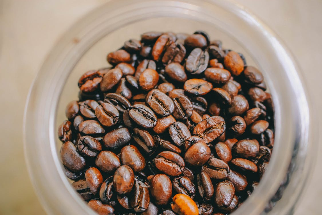 Coffee beans in a jar on a table
