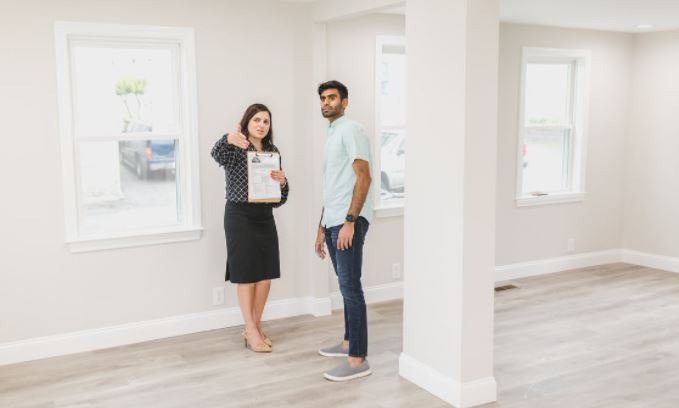 woman explaining the interior of a house