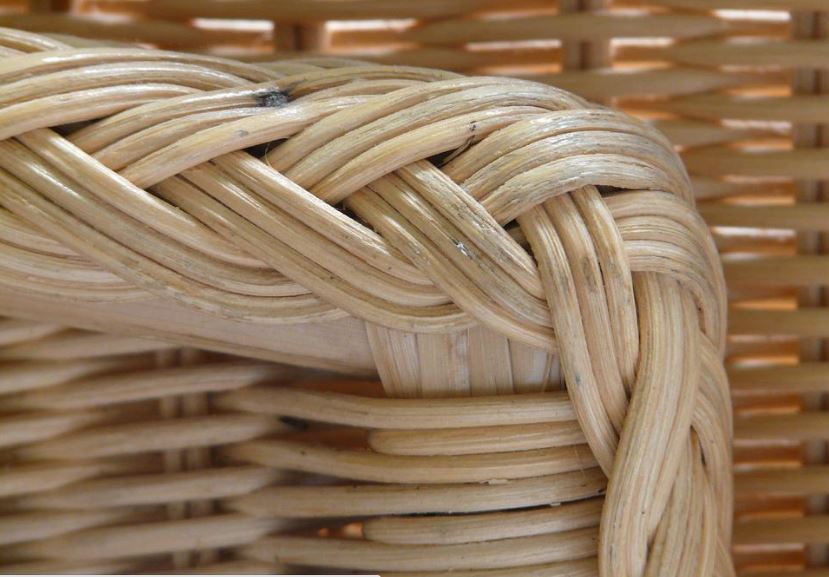 a close up of a rattan chair with scratches and marks