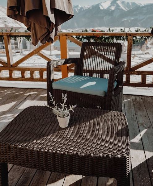 brown, synthetic rattan chair and table