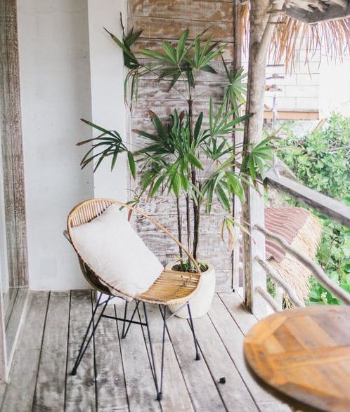 a lounge wicker chair on a wooden tropical terrace