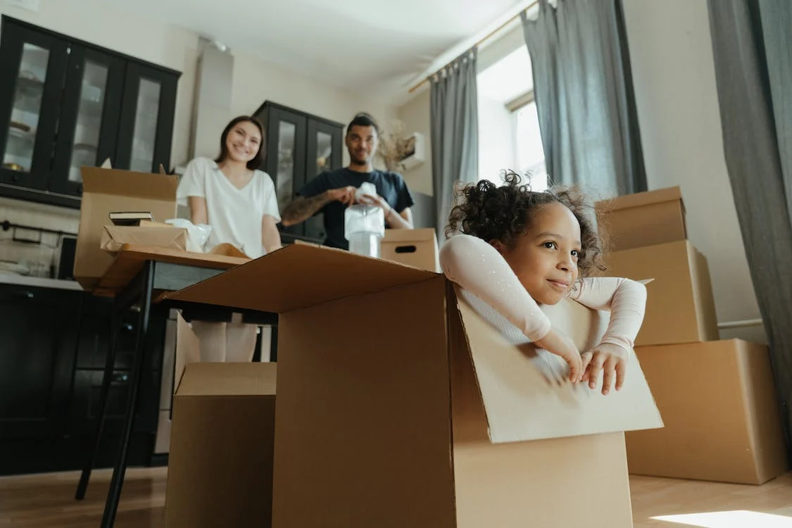A little girl playing in a box