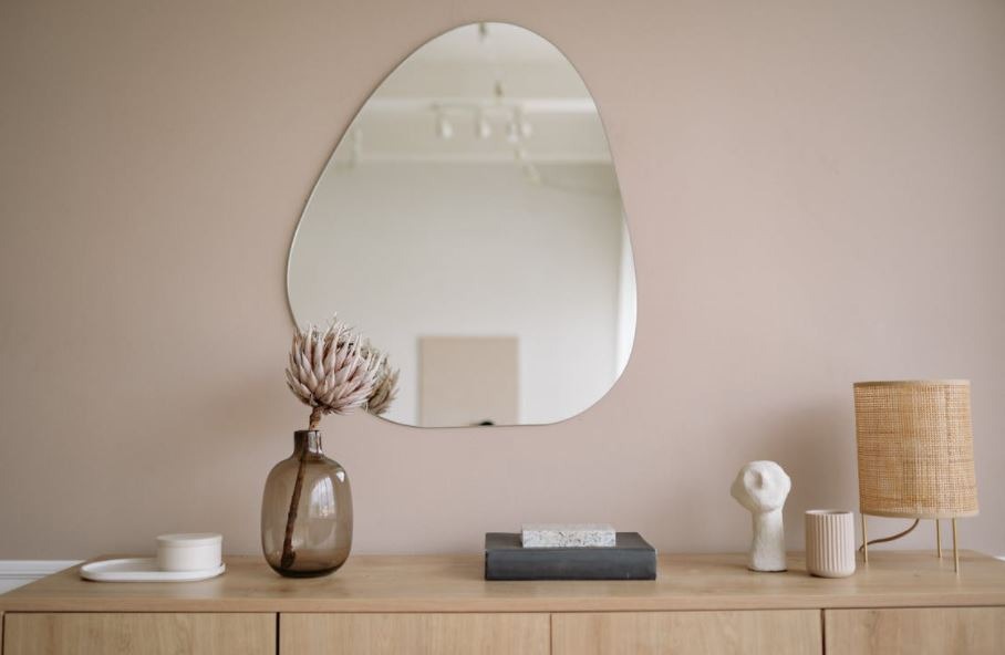 a decorative mirror above a cabinet