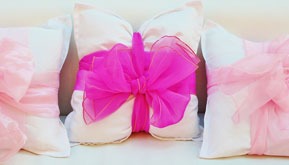 Start by adding pink accessories like pillows, drapes or rugs