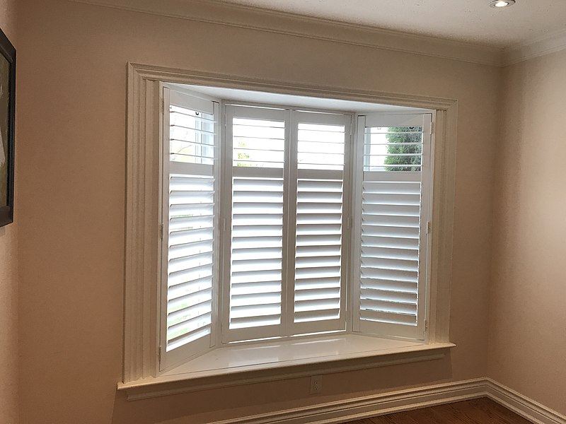 White shutters fitted to a bay window