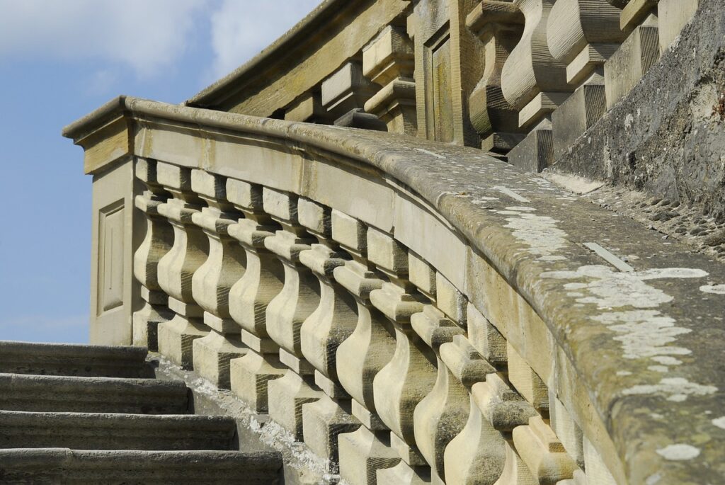 A weathered, natural stone balustrade in an outdoor building