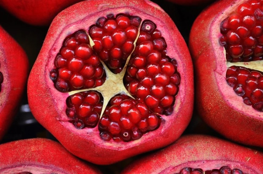 sliced off pomegranate fruit showing its arils