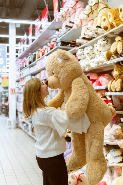 A woman with a giant teddy bear