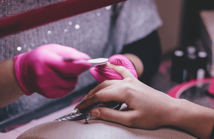 An expert stylist doing a manicure