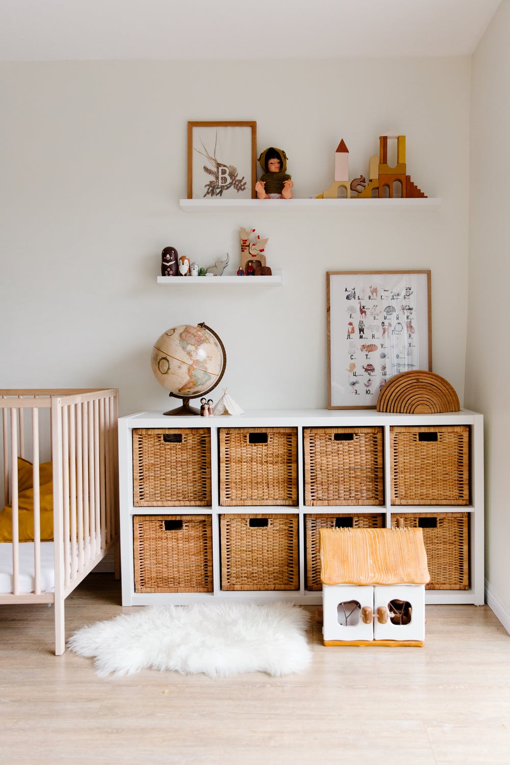 Crib and wooden furniture placed in children's bedroom.