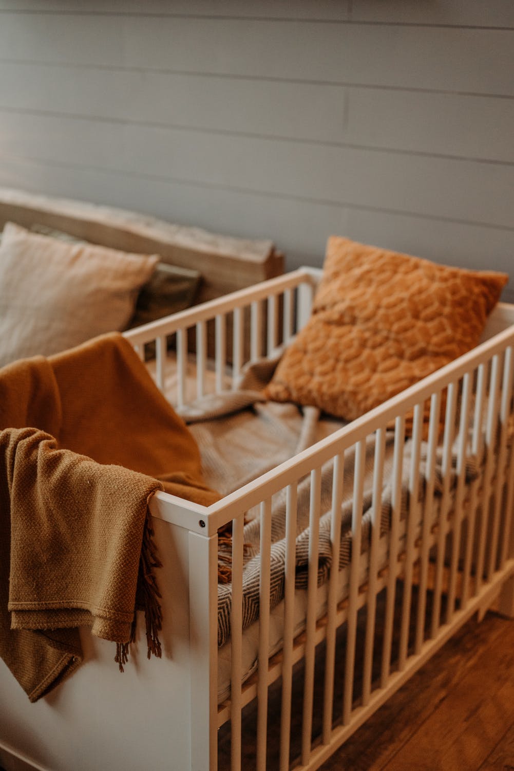 White wooden crib with high rails.