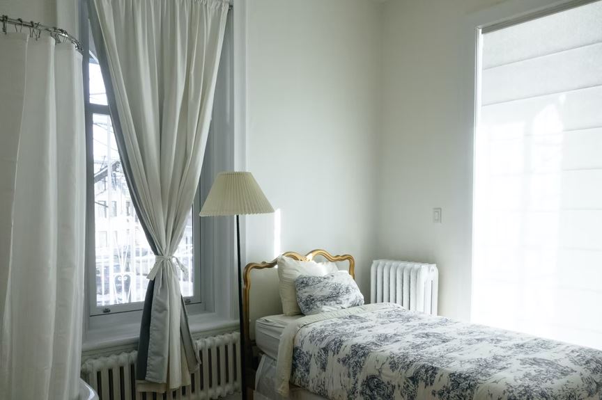 an apartment bedroom with a nice curtain