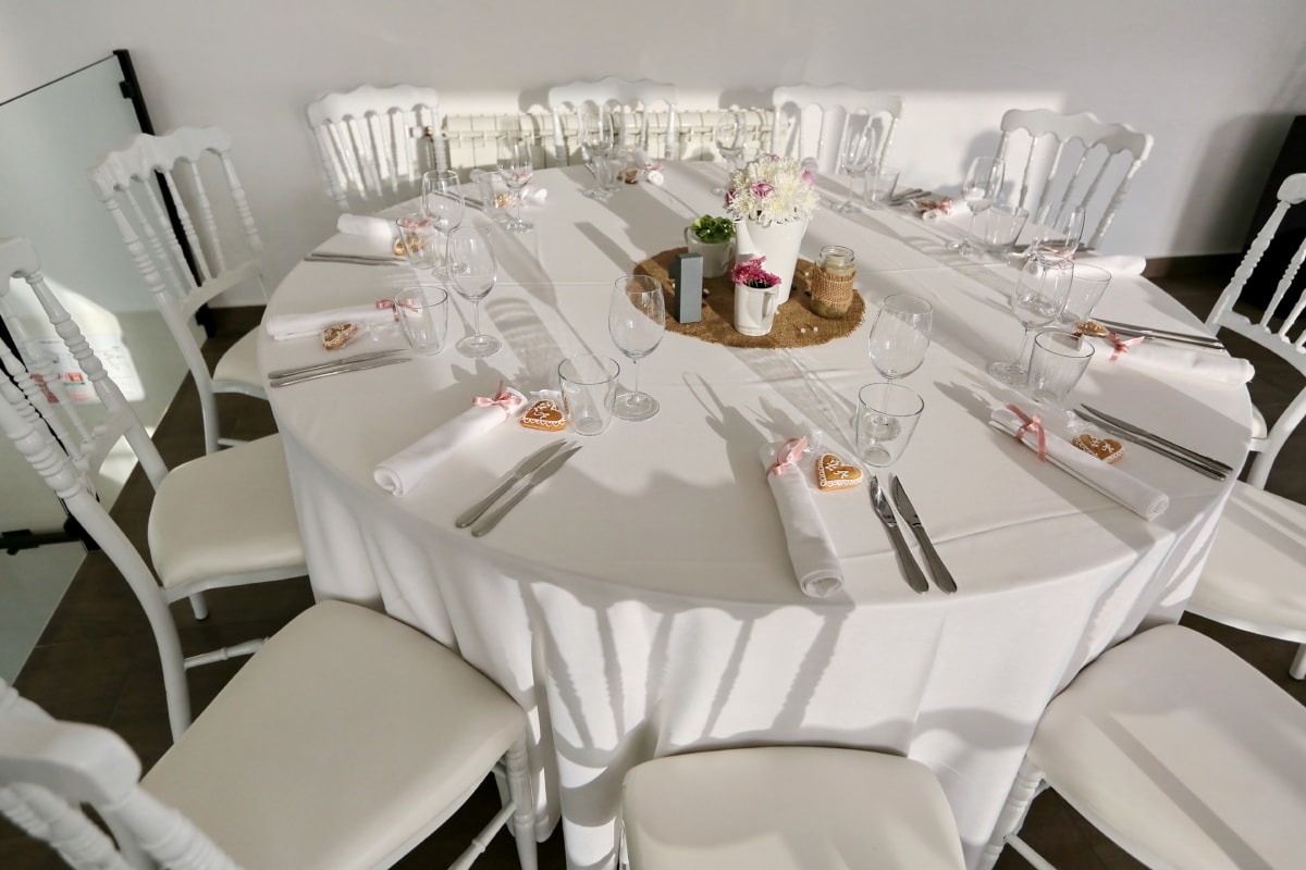 A table set for a party with white tablecloth