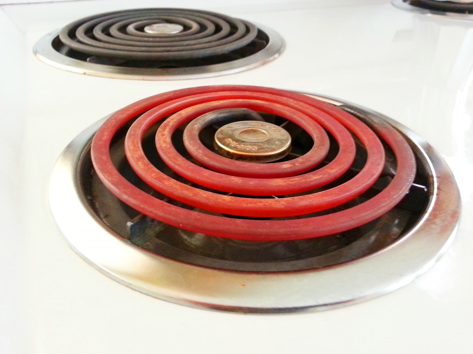 An electric coil cooktop stove with one burner on