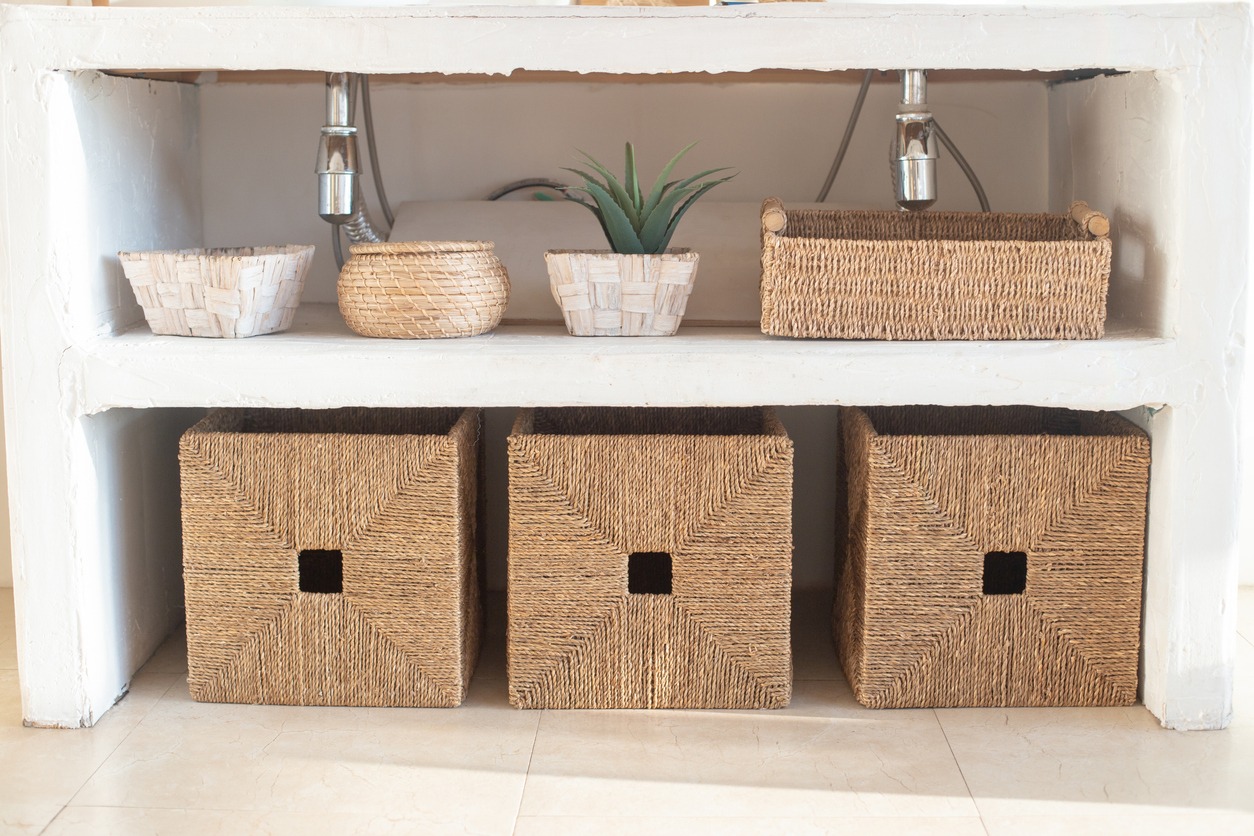 An open shelving with wicker boxes