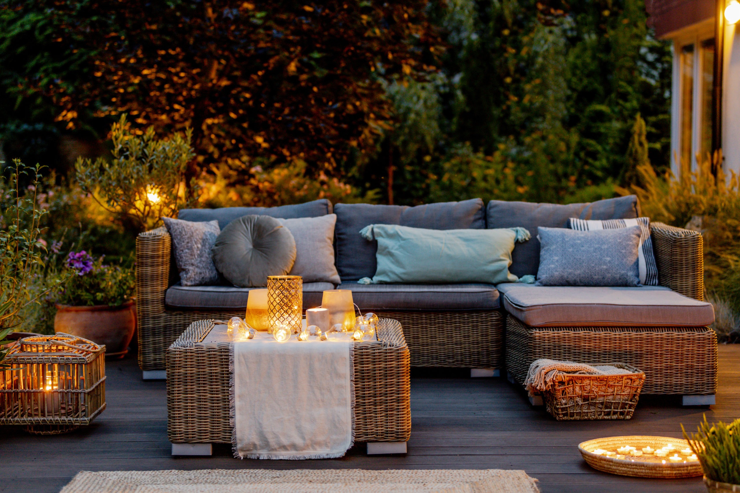 evening time at terrace with rattan furniture, candles on a rattan table