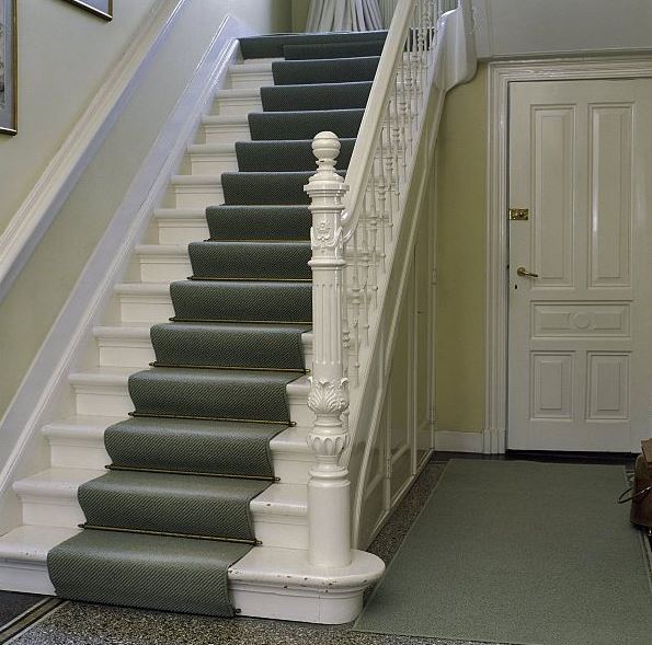 White staircase with gray carpet runners