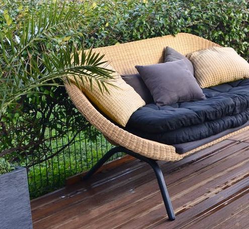 a stylish wicker sofa in a patio