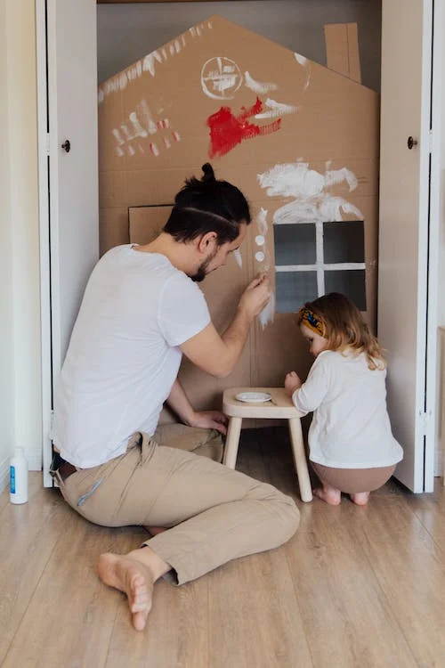 A father and daughter decorating the room