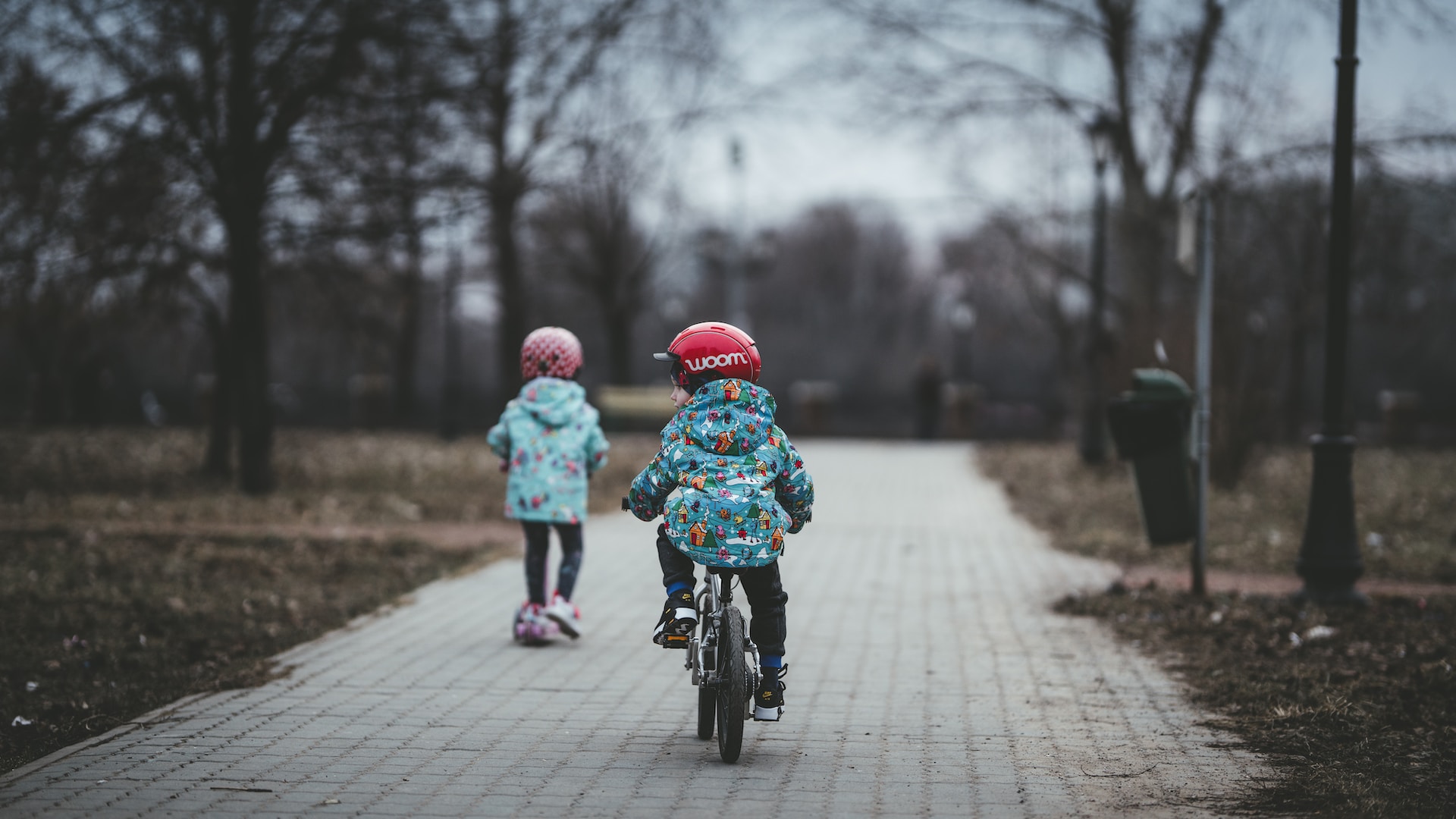 two kids geared up for riding bicycles
