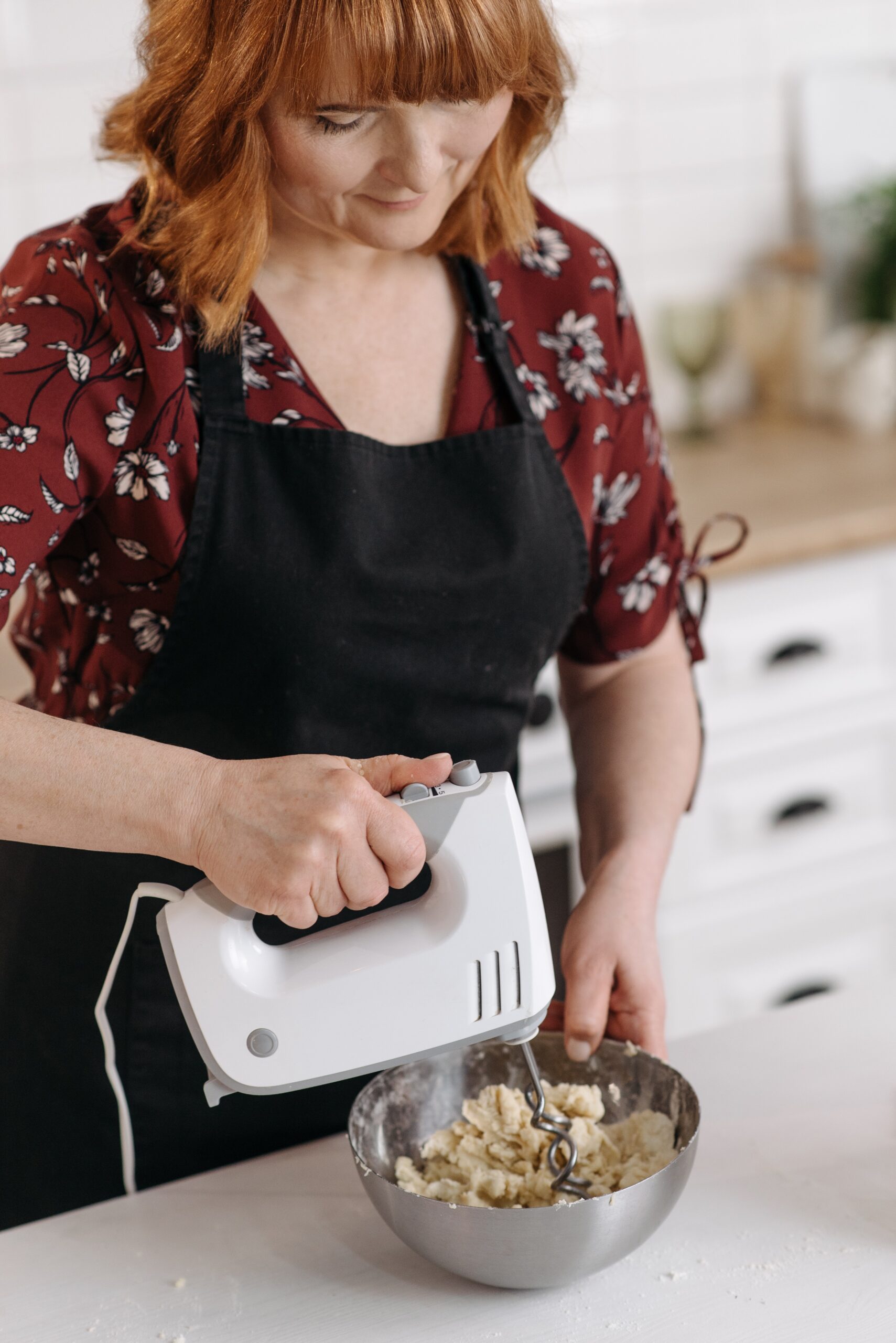 a woman using a hand mixer